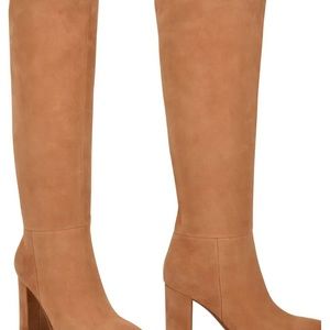 Wide calf tall boot is with a pointed toe, pull-on silhouette & block heel.